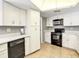 Well-lit kitchen with white cabinets, black appliances, and tile flooring at 5181 Sandy Shore Ave, Sarasota, FL 34242