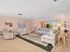 Cozy living room with neutral tones, tile flooring, comfortable seating, and a bright window view at 5181 Sandy Shore Ave, Sarasota, FL 34242