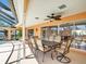 Outdoor dining area on the patio, perfect for enjoying meals with a view of the pool and waterfront at 5181 Sandy Shore Ave, Sarasota, FL 34242