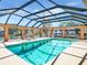Waterfront pool area surrounded by a screen enclosure providing a relaxing outdoor oasis at 5181 Sandy Shore Ave, Sarasota, FL 34242