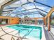 Enclosed swimming pool with clear blue water, lounge chairs, and views of the surrounding property at 5181 Sandy Shore Ave, Sarasota, FL 34242