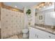 Bathroom featuring a shower/tub combo, granite countertops, a decorative mirror, and a neutral color palette at 526 Allen St, Punta Gorda, FL 33950