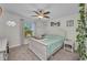 Bright bedroom with a ceiling fan, a comfortable bed with soft blankets, a white color scheme, and natural light at 526 Allen St, Punta Gorda, FL 33950