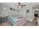 Bedroom with a ceiling fan, comfortable bed with blue bedding, plenty of closet space, and natural light from the window at 526 Allen St, Punta Gorda, FL 33950