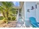 Side of house showcases desert landscaping with a small front porch and an ocean theme chair at 526 Allen St, Punta Gorda, FL 33950