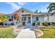 Inviting front porch featuring a decorative door, lush landscaping and a small seating area at 526 Allen St, Punta Gorda, FL 33950