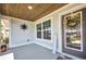 Charming covered porch with wood ceiling detail, welcome sign, and decorative door at 526 Allen St, Punta Gorda, FL 33950
