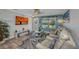 Inviting living room with hardwood floors, a ceiling fan, comfortable seating, and large windows that provide natural light at 526 Allen St, Punta Gorda, FL 33950