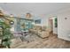 Cozy living room with hardwood floors, a ceiling fan, comfortable seating, and natural light from the window at 526 Allen St, Punta Gorda, FL 33950