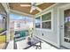 Inviting screened porch featuring cozy seating, ceiling fan, and tranquil views at 526 Allen St, Punta Gorda, FL 33950