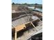 Construction image showing a foundation with a rebar grid, wooden forms, and a scenic pond in the background at 7 Sunflower Dr, Placida, FL 33946