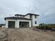 Modern two-story home featuring a white exterior, black trim, and an attached two-car carport at 7 Sunflower Dr, Placida, FL 33946
