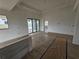 Open-concept living area featuring neutral walls, wood-look tile flooring, and sliding glass doors at 7 Sunflower Dr, Placida, FL 33946