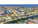 Aerial view of waterfront homes with canals, docks, and community amenities near the coast at 80 Hibiscus Dr, Punta Gorda, FL 33950