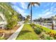 A landscaped backyard has a walkway to a boat dock and canal at 80 Hibiscus Dr, Punta Gorda, FL 33950