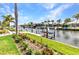 A landscaped backyard has a walkway to a boat dock and canal at 80 Hibiscus Dr, Punta Gorda, FL 33950