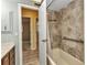 Bathroom featuring a tiled shower/tub and a doorway leading to the bedroom and hallway at 80 Hibiscus Dr, Punta Gorda, FL 33950