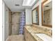 Bathroom features a granite countertop with double sinks and a large, tiled shower with safety bars at 80 Hibiscus Dr, Punta Gorda, FL 33950