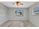 Carpeted bedroom with bright natural light and a ceiling fan at 80 Hibiscus Dr, Punta Gorda, FL 33950