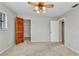 This bedroom includes a window, closet, ceiling fan and multiple doorways at 80 Hibiscus Dr, Punta Gorda, FL 33950
