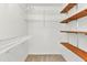 Walk-in closet with wooden shelves and metal storage, ready for organization at 80 Hibiscus Dr, Punta Gorda, FL 33950