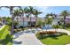 Charming home with lush landscaping, a circular driveway, and mature trees, offering a serene and inviting atmosphere at 80 Hibiscus Dr, Punta Gorda, FL 33950