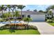 Inviting home with a well-manicured lawn, mature trees, and a spacious driveway, offering both comfort and curb appeal at 80 Hibiscus Dr, Punta Gorda, FL 33950