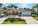 Attractive home with a well-kept lawn, lush landscaping, and mature trees, offering a blend of comfort and charm at 80 Hibiscus Dr, Punta Gorda, FL 33950