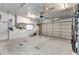 Spacious garage area, equipped with a lawnmower and functional garage door at 80 Hibiscus Dr, Punta Gorda, FL 33950