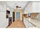 Well-lit kitchen boasts granite countertops, white cabinets, and stainless steel appliances at 80 Hibiscus Dr, Punta Gorda, FL 33950