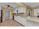 Bright kitchen featuring granite countertops, white cabinets, and stainless steel appliances at 80 Hibiscus Dr, Punta Gorda, FL 33950