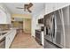 Modern kitchen featuring white cabinets, stainless steel appliances, granite countertops, and tile flooring at 80 Hibiscus Dr, Punta Gorda, FL 33950
