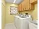 Laundry room featuring washer, dryer, and overhead cabinets at 80 Hibiscus Dr, Punta Gorda, FL 33950