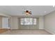 Neutral living room with tile flooring, a large window, and a white front door to the left at 80 Hibiscus Dr, Punta Gorda, FL 33950
