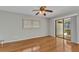Bright main bedroom with wood floors, a ceiling fan, and sliding door to the lanai at 80 Hibiscus Dr, Punta Gorda, FL 33950