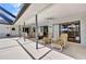 Covered patio with lounge seating and dining area with direct access to backyard and pool at 80 Hibiscus Dr, Punta Gorda, FL 33950
