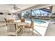 A screened-in pool and patio features views of the water and boat dock at 80 Hibiscus Dr, Punta Gorda, FL 33950