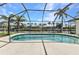 A screened-in pool features stunning views of the canal at 80 Hibiscus Dr, Punta Gorda, FL 33950