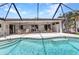 A kidney-shaped pool is adjacent to an outdoor dining and lounge area at 80 Hibiscus Dr, Punta Gorda, FL 33950