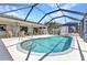 A kidney-shaped pool is adjacent to an outdoor dining and lounge area at 80 Hibiscus Dr, Punta Gorda, FL 33950