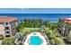 Serene aerial view shows a community pool, manicured gardens, and stunning waterfront location at 95 N Marion Ct # 135, Punta Gorda, FL 33950