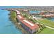 Aerial view showcasing waterfront condos, a scenic lake, and lush landscaping in the community at 95 N Marion Ct # 135, Punta Gorda, FL 33950