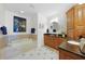 Bathroom features a large soaking tub, wood cabinets, and tile flooring at 95 N Marion Ct # 135, Punta Gorda, FL 33950