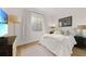 Bedroom featuring a bed, TV, wood flooring, and a large window at 95 N Marion Ct # 135, Punta Gorda, FL 33950