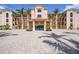 Elegant building exterior showcases lush landscaping, a grand entrance, and convenient parking at 95 N Marion Ct # 135, Punta Gorda, FL 33950