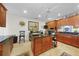Cozy kitchen with wood cabinets, granite counters, and a convenient island workspace at 95 N Marion Ct # 135, Punta Gorda, FL 33950