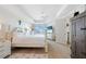This is a bright main bedroom featuring a four-poster bed, wood flooring, and ceiling fan at 95 N Marion Ct # 135, Punta Gorda, FL 33950