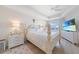 Bright main bedroom featuring a four-poster bed, water view, and light wood flooring at 95 N Marion Ct # 135, Punta Gorda, FL 33950