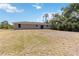 A backyard features a spacious lawn area at 105 Biscayne Dr, Port Charlotte, FL 33953