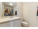 A full bathroom includes a shower, a toilet, and a vanity at 105 Biscayne Dr, Port Charlotte, FL 33953